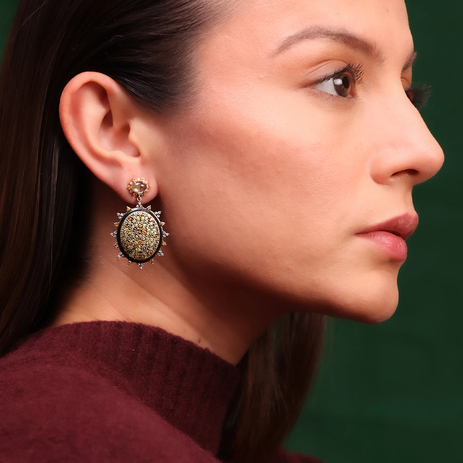 Sunburst earrings featuring pavé sapphires in warm, sun-kissed hues with faceted Green Amethyst stud tops.
