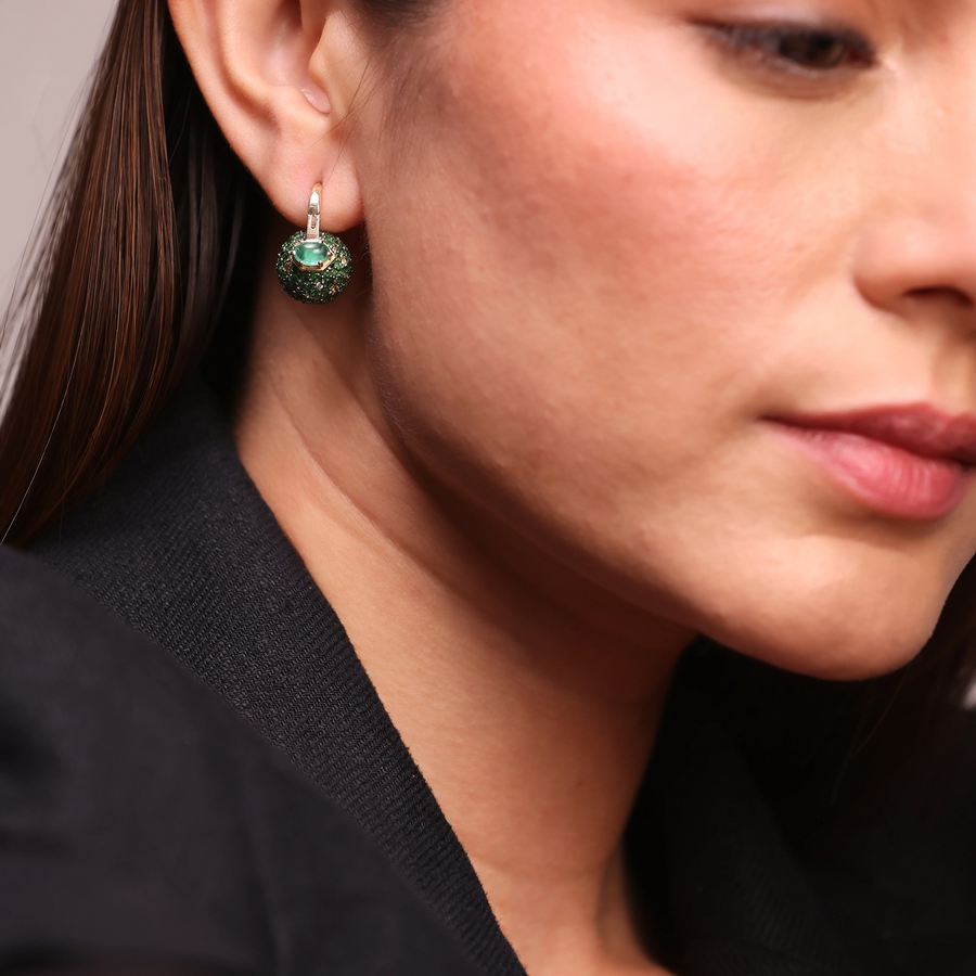 Forest-inspired earrings with pavé tsavorite, yellow sapphire, and emerald, featuring a central emerald set in gold.
