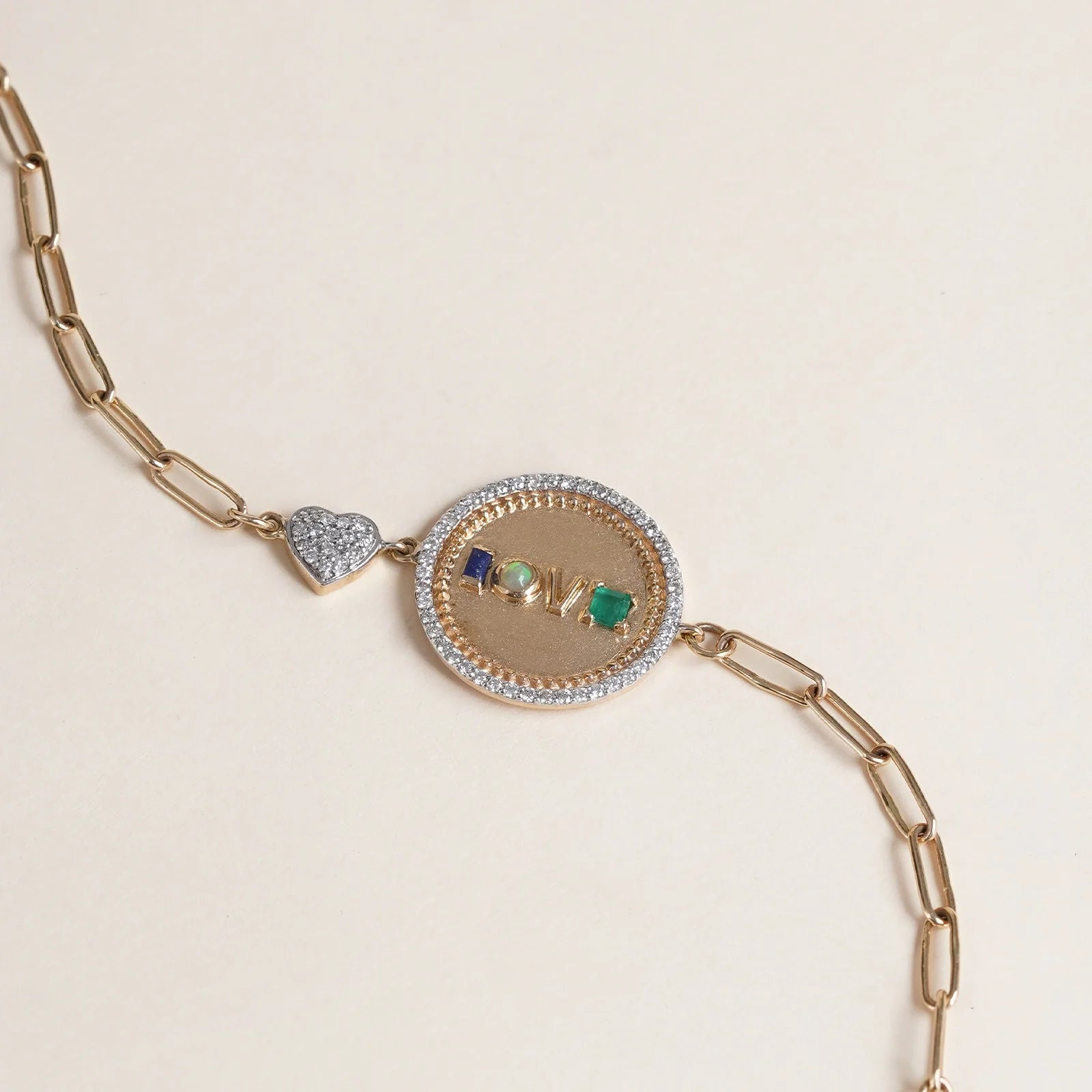 Gold Love Medallion Bracelet with acrostic gemstones spelling LOVE and natural diamonds.