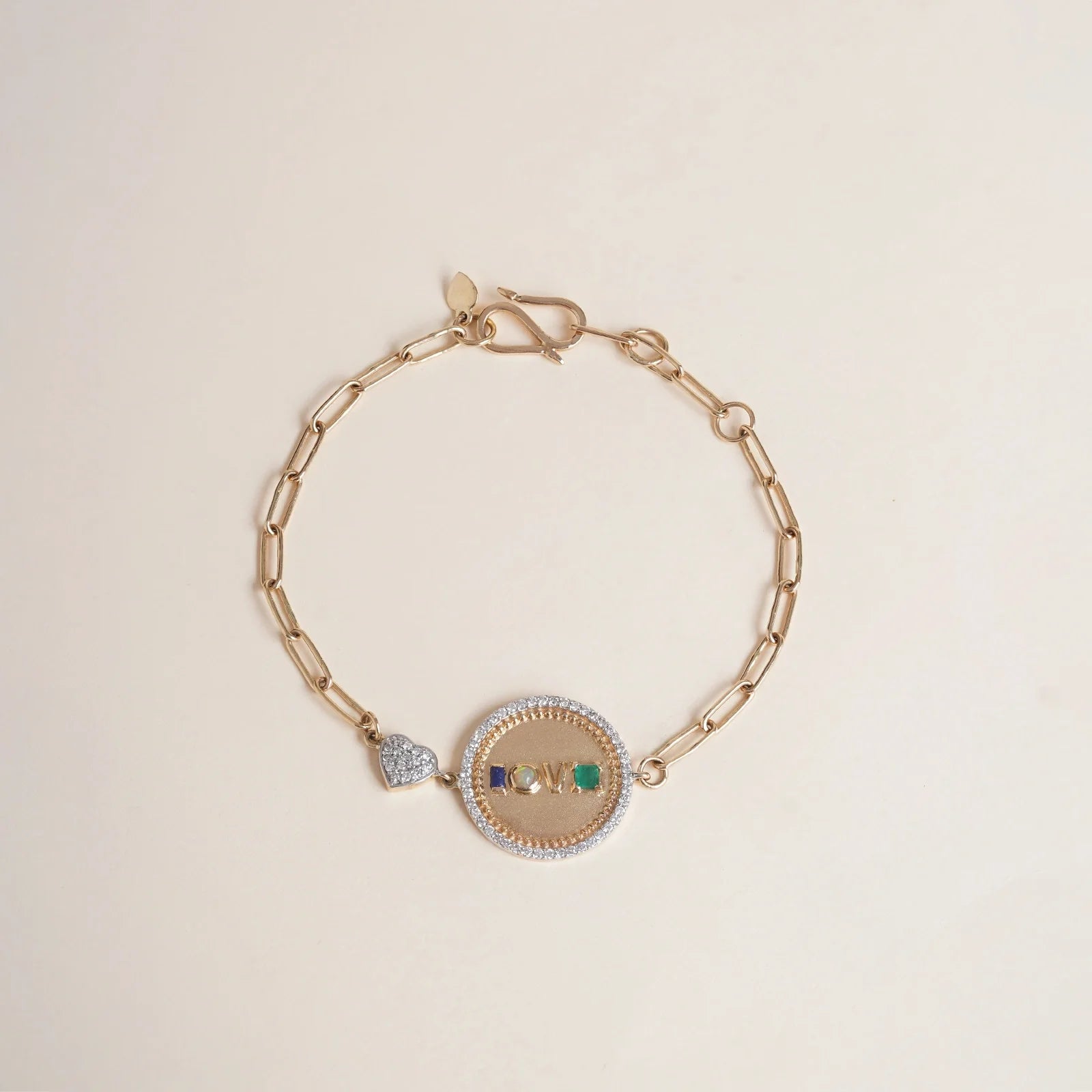Gold Love Medallion Bracelet with acrostic gemstones spelling LOVE and natural diamonds.